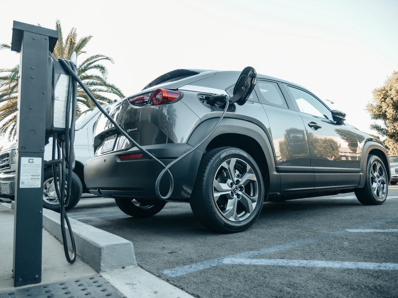 Crafting Captivating Headlines: Your awesome post title goes here Modern electric vehicle charging at an outdoor station in daylight.